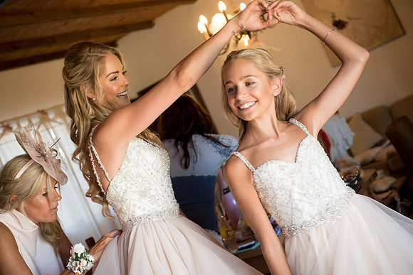 Beautiful bride spins her junior bridesmaid at El Cortijo De Los Caballos in Estepona, Spain.